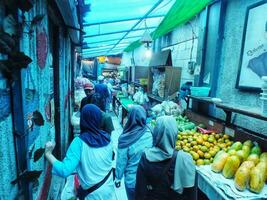 22 November 2023. Bandung City, West Java, Indonesia. Morning atmosphere at the entrance to the Cihapit Traditional Market. Traders and Buyers with their respective activities. photo
