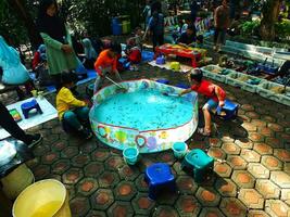 Bandung City, West Java, Indonesia. 19 October 2023. Bright mornings days on weekends, happy childhoods, playing in city parks. Family gathering making fun with children. photo