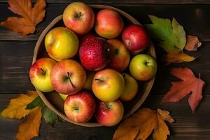 AI generated apples in a bowl on a wooden table with autumn leaves photo