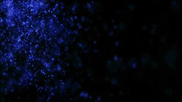 Blurred blue abstract background of bokeh and small round particles of energy magical holiday flying dots on a black background video