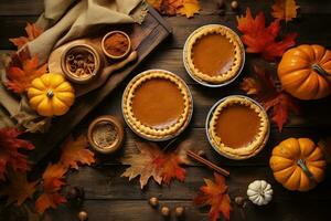 pumpkin pies and other fall decorations on a wooden table photo