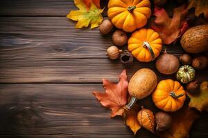 autumn background with pumpkins, acorns and leaves on wooden table photo