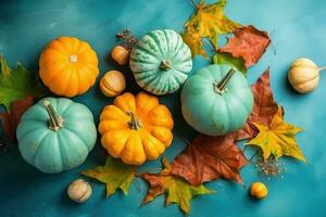 colorful pumpkins and leaves on a blue background photo