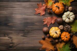 autumn background with pumpkins, acorns and leaves on wooden table photo