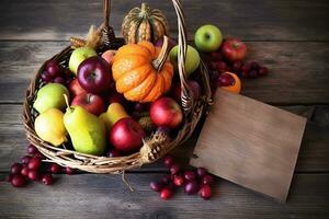 a basket with apples, pumpkins and other fruits on a wooden table photo