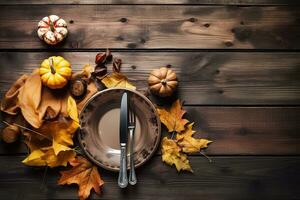 autumn table setting with pumpkin, leaves and knife photo