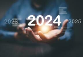 Businessman using laptop computer search 2024 trends,happy new year concept digital trends,industry and business trend of world full modernity advanced technology,artificial intelligence or AI,banner photo