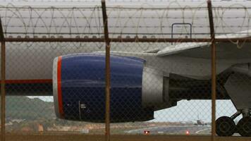 Jet Engine and Wing of an Airplane. Footage of plane behind fence airport video