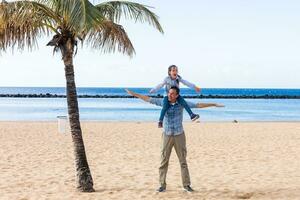 Father and Daughter playing at the beach photo