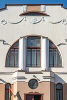 windows with decorative elements on an old wooden or brick building photo