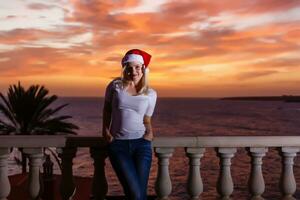 Woman admiring sunset from her balcony photo