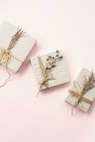 Gift boxes decorated dried flowers top view. Holidays present greeting concept. photo