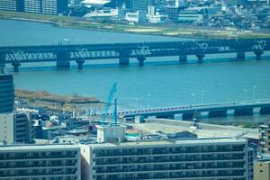 A panorama cityscape near Yodo river in Osaka telephoto shot photo