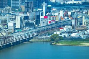A panorama cityscape near Yodo river in Osaka telephoto shot photo