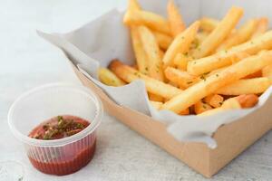 French fries, finger chips on white table background photo