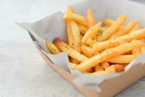 French fries, finger chips on white table background photo