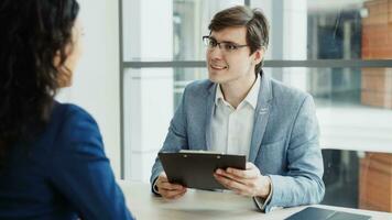 HR male manager shaking hand to female candidate after having job interview in modern office indoors photo