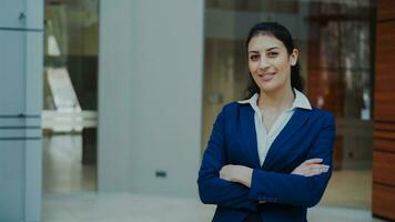 Portrait of successful businesswoman smiling and looking into camera in modern office indoors photo