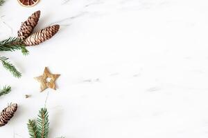 Christmas composition. Fir tree branches, red decorations on gray background, Flowers composition. White and purple flowers on marble background, Eucalyptus leaves, winter, top view. Christmas gift. photo