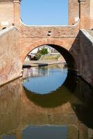 Comacchio ,Italy-June 2, 2023-people stroll in Comacchio in front off the  famous three bridges during a sunny day photo