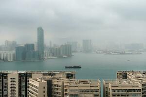 Hong Kong,March 26,2019-Panorama of skyscrapers of hong kong bay during a hazy day photo