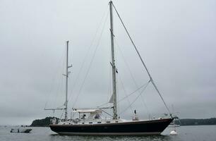 Large Luxury Sailboat Anchored in a Harbor photo