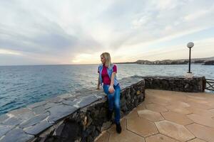 Family holiday on Tenerife, Spain. Mother with children outdoors on ocean. Portrait travel tourists - mom with kids. Positive human emotions, active lifestyles. Happy young family on sea beach photo