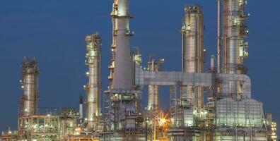 refinery plant exterior structure against dusky blue sky photo