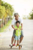 grandfather and grandson playing with happiness in home village park photo