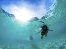 snorkeling over clear water of andaman sea thailand photo