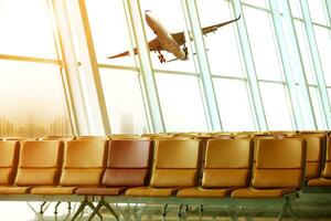 passenger plane flying outside airport terminal building photo