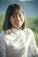 toothy smiling face of beautiful asian younger woman photo