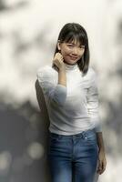 portrait of asian younger woman relaxing with smiling face standing outdoor photo