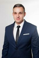 Portrait of handsome man in black blue suit photo