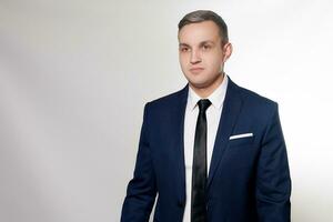 Portrait of handsome man in black blue suit photo