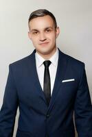 Portrait of handsome man in black blue suit photo