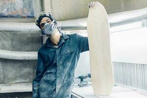 A carpenter cuts a board with an electric jigsaw. photo