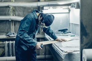 A carpenter cuts a board with an electric jigsaw. photo