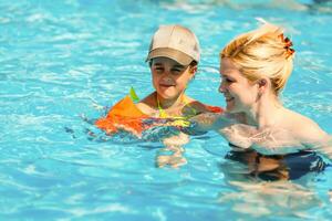 Mother and the daughter at pool, summer holidays photo