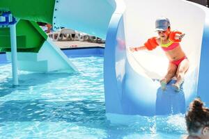 Cute toddler girl playing in swimming pool photo