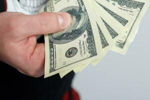 Young man throws money to camera. photo