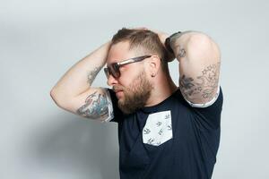 Brutal bearded boy with tattoo photo