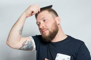 Brutal bearded boy with tattoo photo