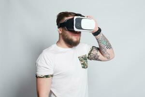 Color shot of a young man looking through a virtual reality photo