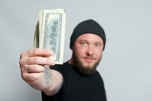 Young man throws money to camera. photo