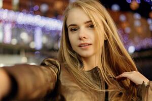 woman smiling in the night against evening lights bokeh photo