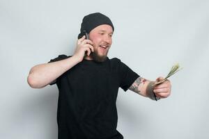 Young man throws money to camera. photo