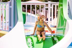 Cute toddler girl playing in swimming pool photo