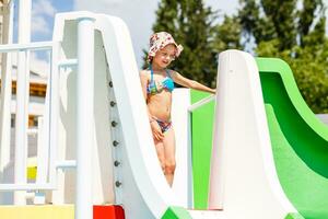 Cute toddler girl playing in swimming pool photo