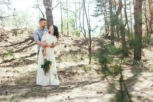 Wedding walk in the pine forest. Sunny day. photo